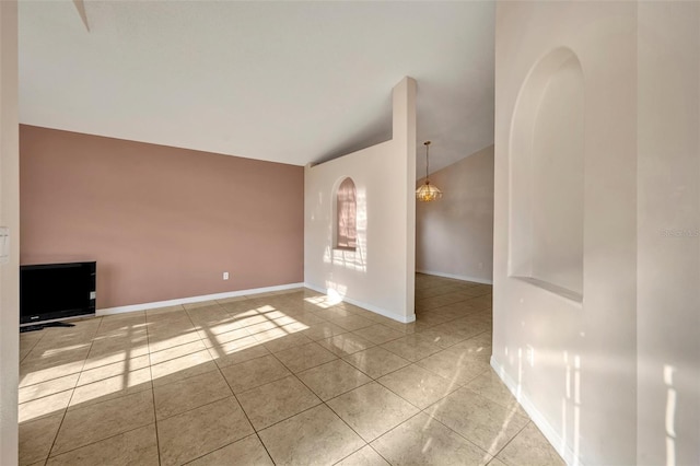 unfurnished living room with light tile patterned floors, vaulted ceiling, and a notable chandelier