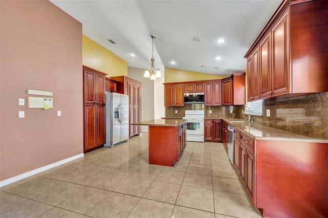 kitchen with backsplash, a notable chandelier, a kitchen island, hanging light fixtures, and appliances with stainless steel finishes