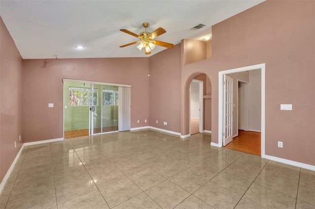 empty room featuring ceiling fan and high vaulted ceiling