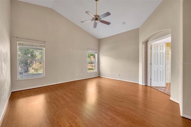 spare room with ceiling fan, high vaulted ceiling, and hardwood / wood-style floors