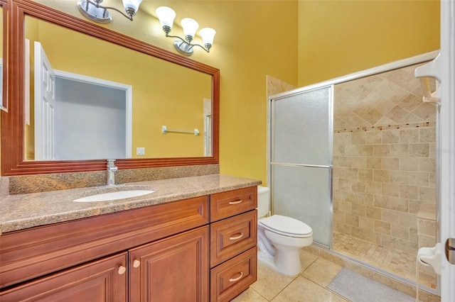 bathroom featuring walk in shower, vanity, tile patterned floors, and toilet