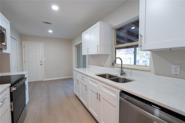 kitchen with light stone countertops, white cabinetry, sink, black range with electric cooktop, and stainless steel dishwasher