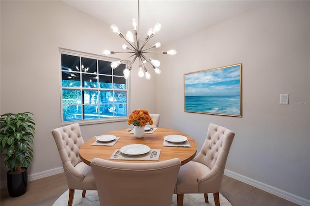 dining area with hardwood / wood-style floors and a notable chandelier