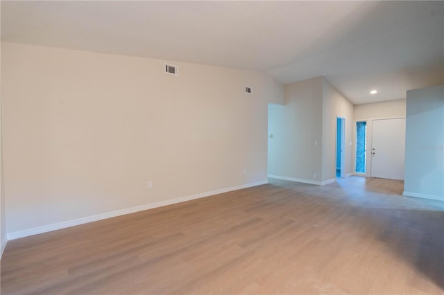 empty room with light hardwood / wood-style flooring