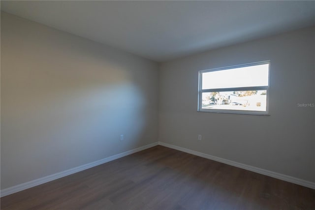 spare room with dark hardwood / wood-style flooring