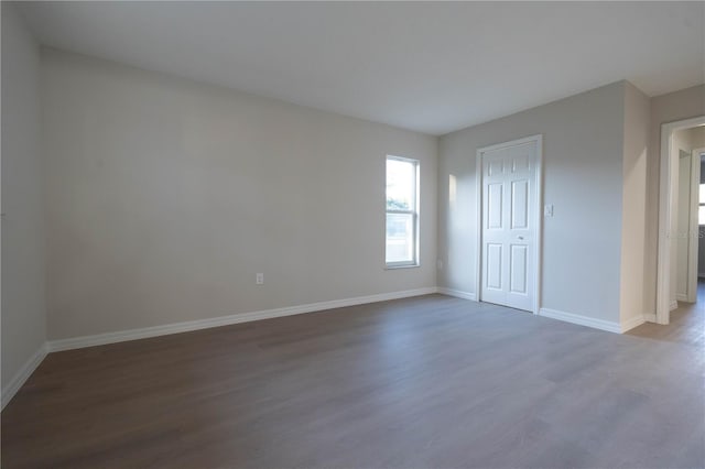 unfurnished room with dark hardwood / wood-style floors