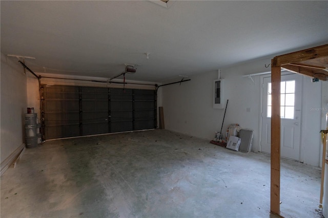 garage featuring electric panel and a garage door opener