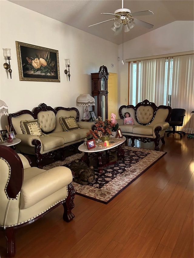 living room featuring hardwood / wood-style floors, vaulted ceiling, and ceiling fan