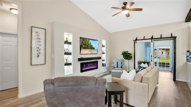 living room featuring light wood-type flooring, vaulted ceiling, and ceiling fan