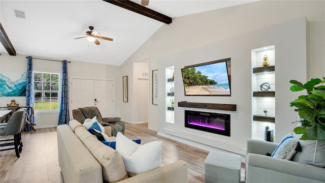 living room with lofted ceiling with beams, ceiling fan, and light wood-type flooring