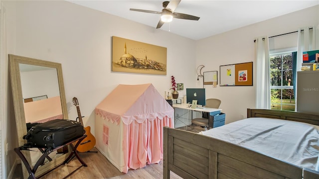 bedroom with ceiling fan and light hardwood / wood-style floors