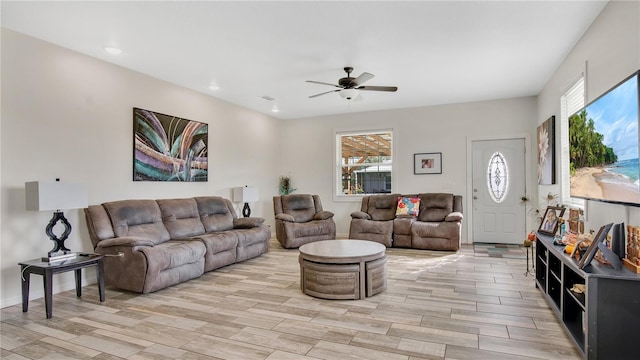 living room with a wealth of natural light and ceiling fan