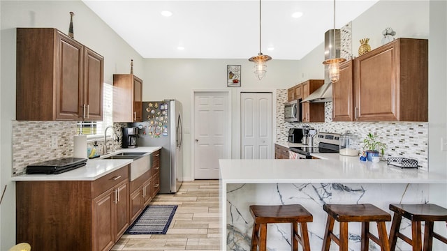 kitchen with stainless steel appliances, tasteful backsplash, a kitchen breakfast bar, kitchen peninsula, and decorative light fixtures