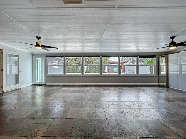 unfurnished sunroom featuring a ceiling fan