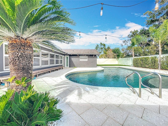 view of swimming pool featuring a patio area, fence, and a fenced in pool