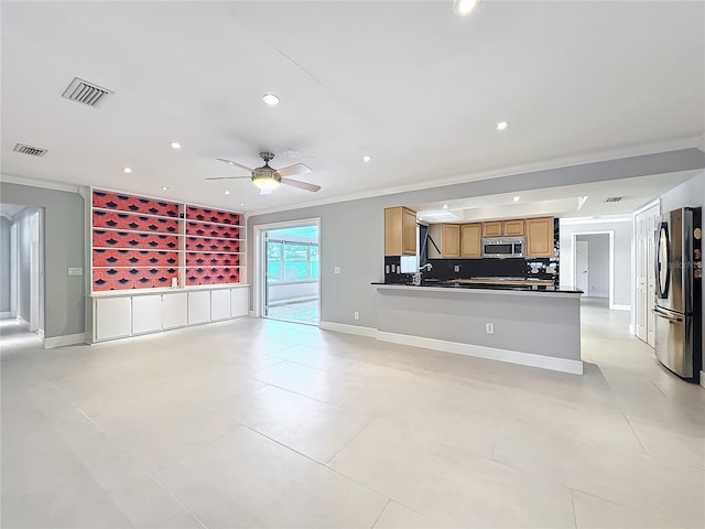 kitchen featuring appliances with stainless steel finishes, dark countertops, visible vents, and a peninsula