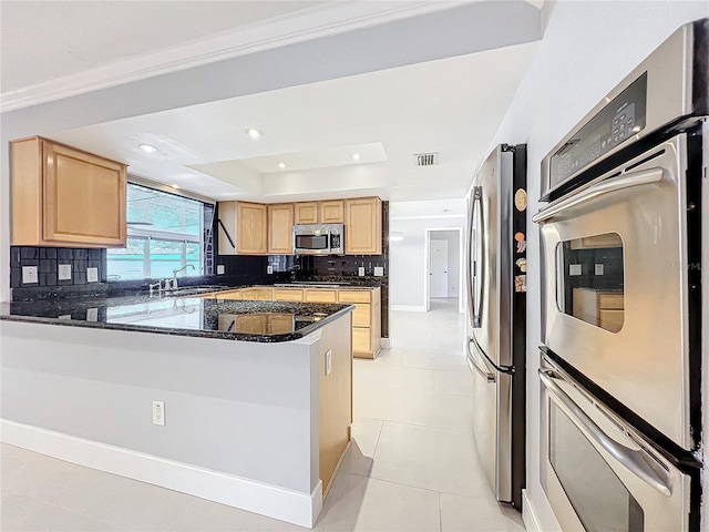 kitchen featuring stainless steel appliances, light tile patterned flooring, backsplash, and visible vents