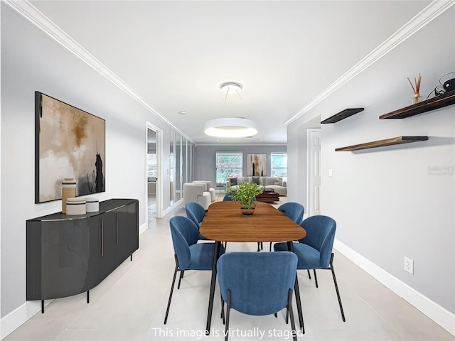 dining area with baseboards and crown molding