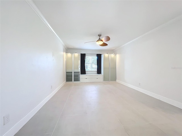 unfurnished room featuring a ceiling fan, light tile patterned floors, baseboards, and crown molding