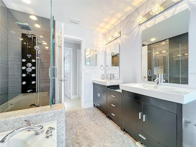 bathroom featuring baseboards, visible vents, vanity, and a shower stall