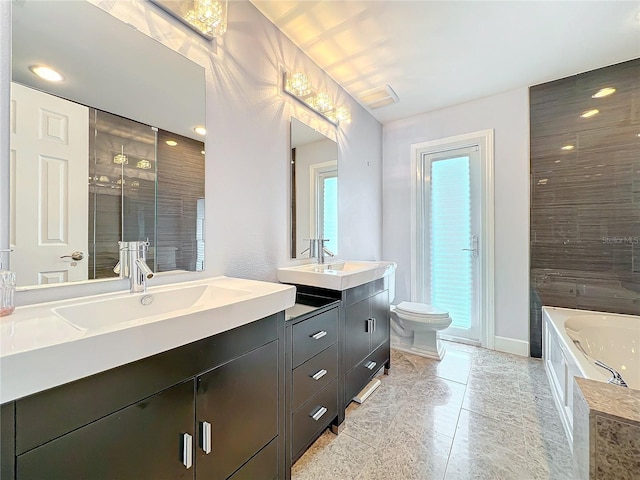 bathroom with a stall shower, a sink, toilet, and double vanity