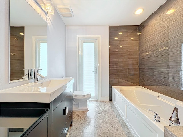 full bath with toilet, a garden tub, visible vents, and vanity