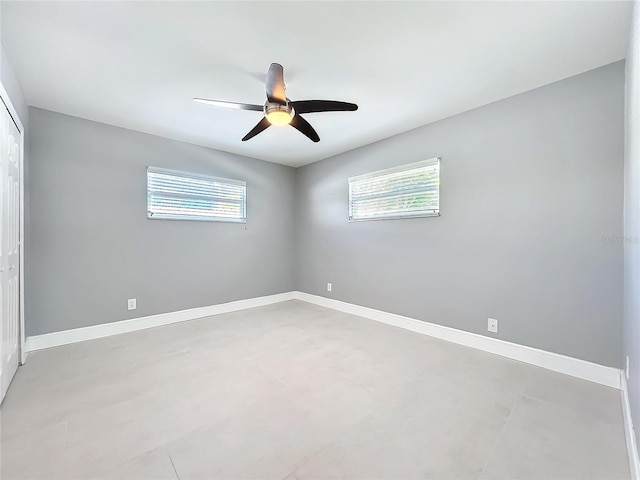 unfurnished bedroom featuring a closet, ceiling fan, and baseboards