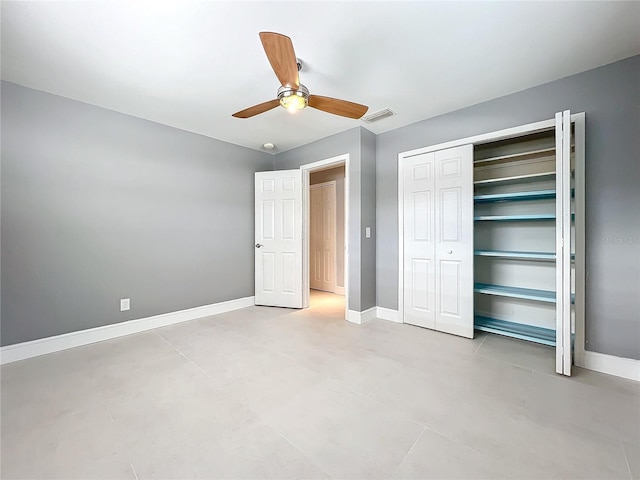 unfurnished bedroom with a closet, visible vents, ceiling fan, and baseboards