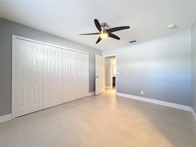 unfurnished bedroom with a closet, visible vents, ceiling fan, and baseboards