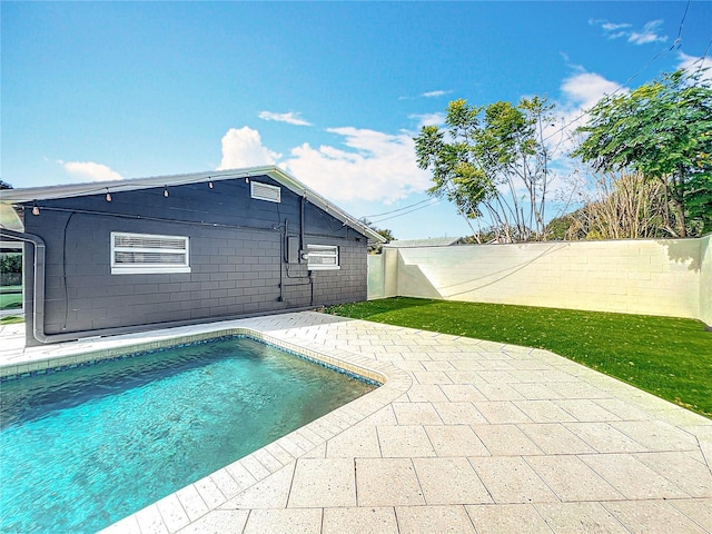 view of swimming pool featuring a patio area, a fenced backyard, and a fenced in pool