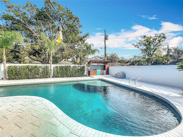 view of pool featuring a patio area, a fenced backyard, a jacuzzi, and a fenced in pool