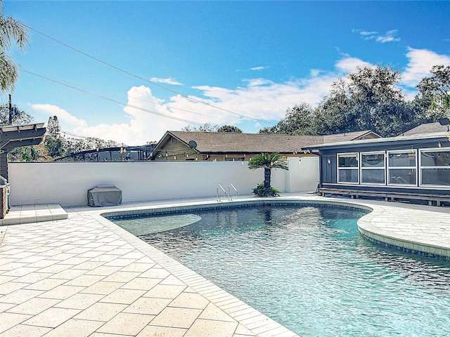 view of pool with a patio area, fence, and a fenced in pool