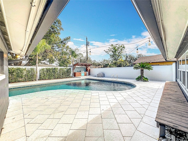 view of swimming pool with a fenced backyard and a fenced in pool