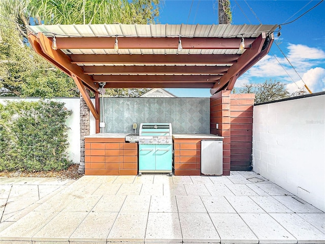 view of patio with fence, grilling area, and area for grilling