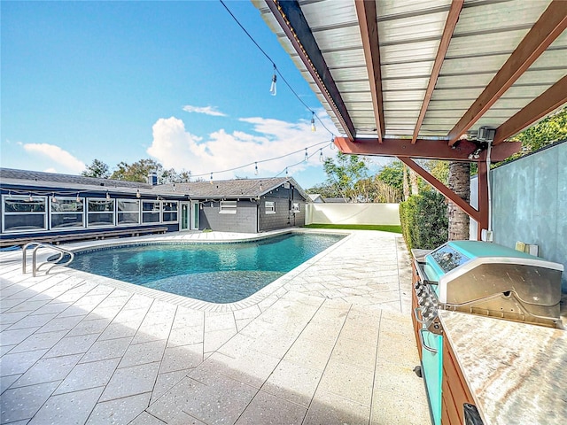 view of swimming pool featuring a fenced in pool, a patio area, a fenced backyard, and area for grilling