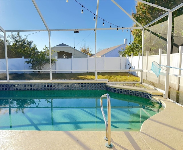 view of swimming pool featuring glass enclosure