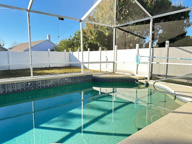 view of pool with glass enclosure