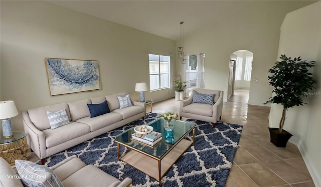 tiled living room featuring a high ceiling