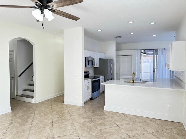 kitchen featuring ceiling fan, sink, light tile patterned flooring, white cabinets, and appliances with stainless steel finishes