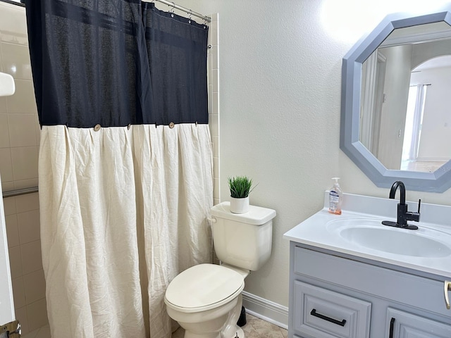 bathroom with curtained shower, vanity, and toilet