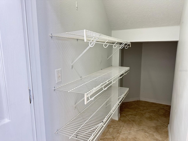 spacious closet with light tile patterned floors