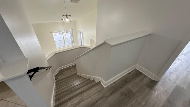 stairs featuring wood-type flooring