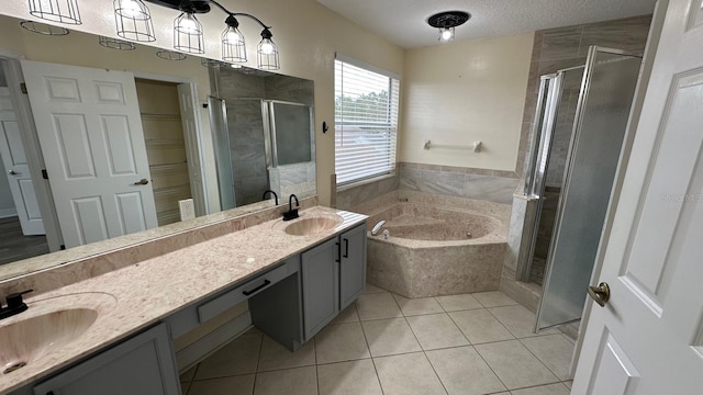 bathroom featuring tile patterned floors, vanity, separate shower and tub, and a textured ceiling