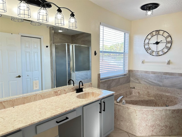 bathroom featuring tile patterned floors, vanity, and shower with separate bathtub