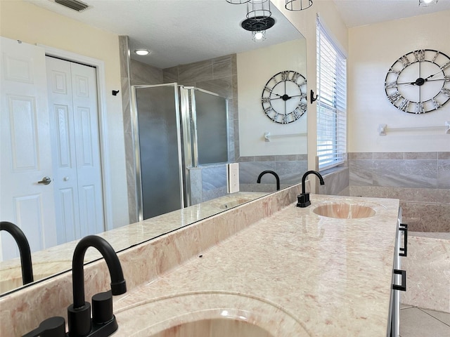 bathroom with vanity, tile patterned floors, and an enclosed shower