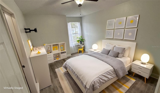 bedroom featuring a textured ceiling, dark hardwood / wood-style flooring, and ceiling fan