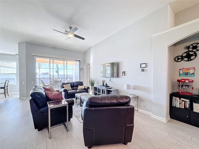 living room with ceiling fan and lofted ceiling