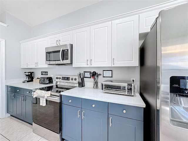 kitchen featuring white cabinets, light tile patterned floors, and appliances with stainless steel finishes