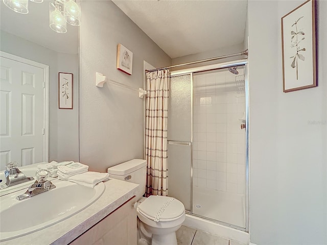 bathroom with vanity, toilet, tile patterned flooring, and walk in shower