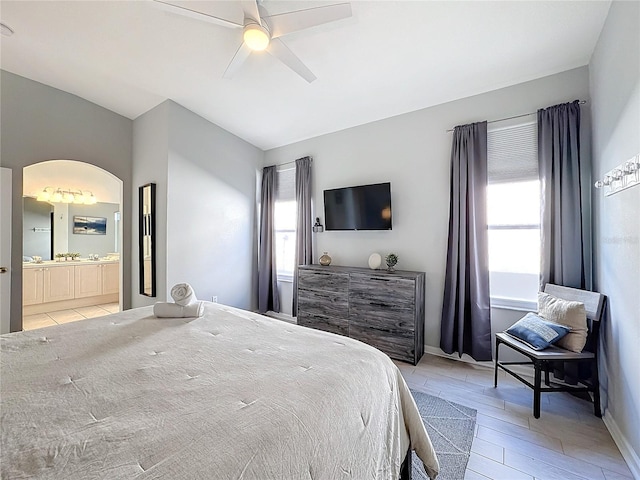 bedroom featuring ceiling fan and ensuite bath